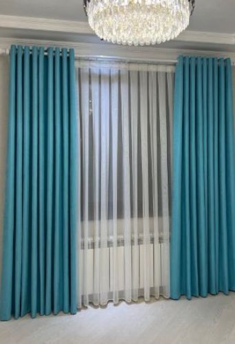 Turquoise curtains and sheer white drapes